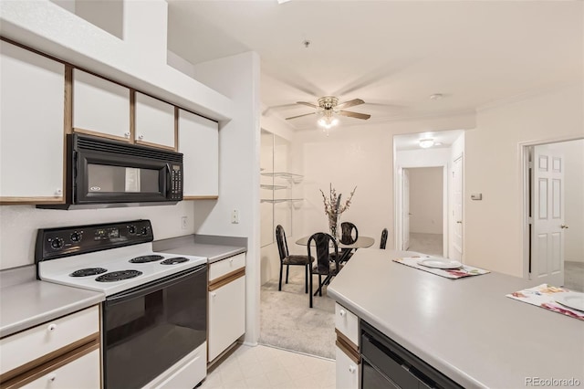 kitchen featuring light carpet, ornamental molding, black appliances, ceiling fan, and white cabinets