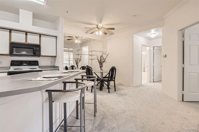 kitchen with ornamental molding, electric range, white cabinetry, light colored carpet, and ceiling fan