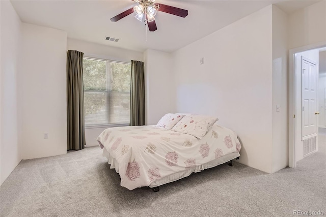 bedroom featuring light carpet and ceiling fan