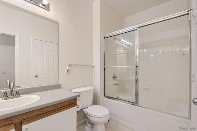 full bathroom with vanity, toilet, tile patterned flooring, and enclosed tub / shower combo