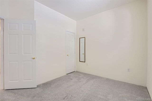 unfurnished room featuring light carpet