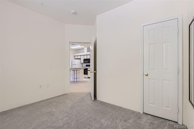 unfurnished room with light carpet