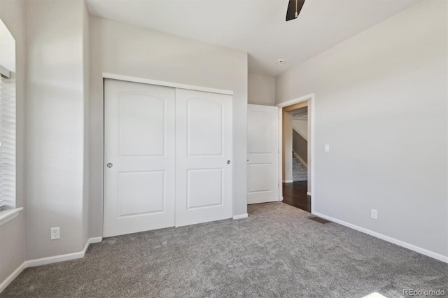 unfurnished bedroom with carpet flooring, ceiling fan, and a closet