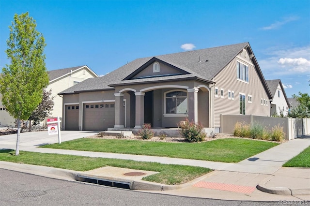 view of front of home featuring a garage, concrete driveway, fence, a front lawn, and a porch