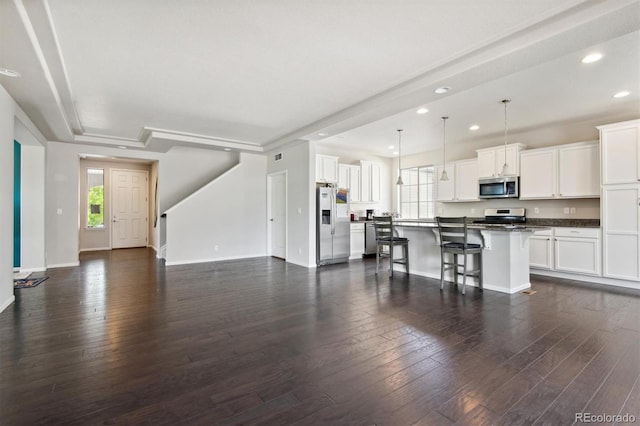 living room featuring baseboards, dark wood-type flooring, and recessed lighting