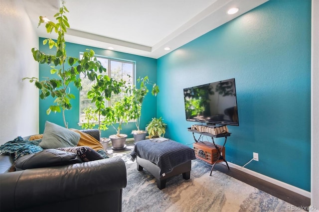 living room featuring baseboards, wood finished floors, and recessed lighting