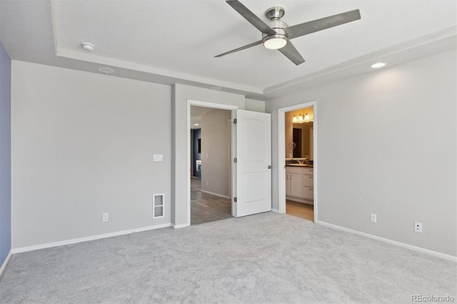 unfurnished bedroom featuring carpet, connected bathroom, visible vents, and baseboards