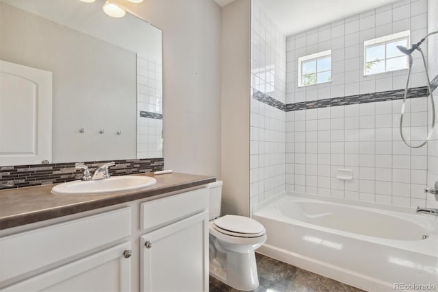 bathroom with tasteful backsplash, vanity, toilet, and bathing tub / shower combination