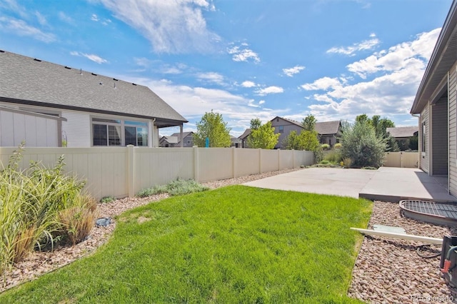 view of yard featuring a patio and a fenced backyard