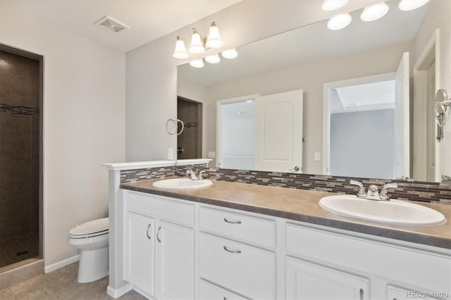 19802 E 54th Ave, Denver, CO 80249 - full bath with toilet, tiled shower, double vanity, tasteful backsplash, and tile patterned flooring