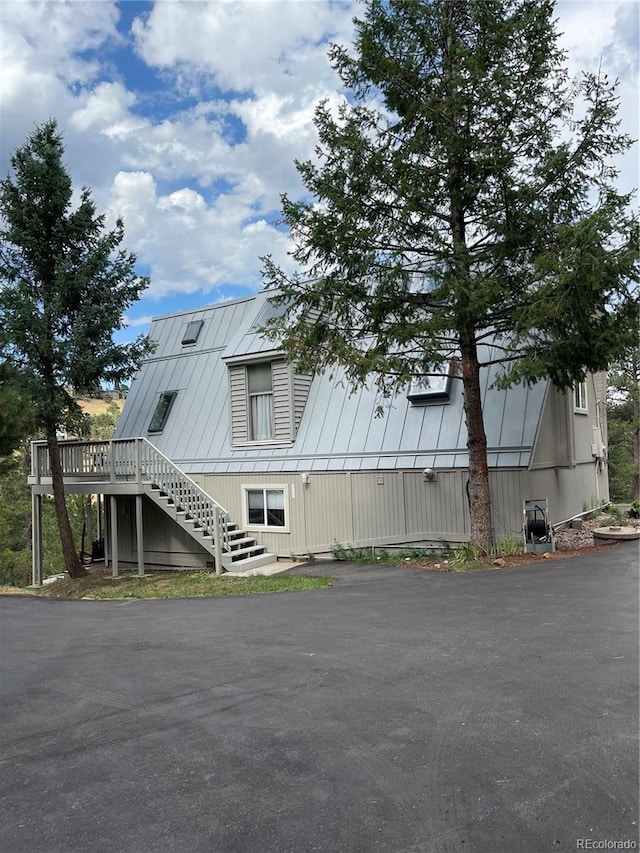 view of property exterior with a deck