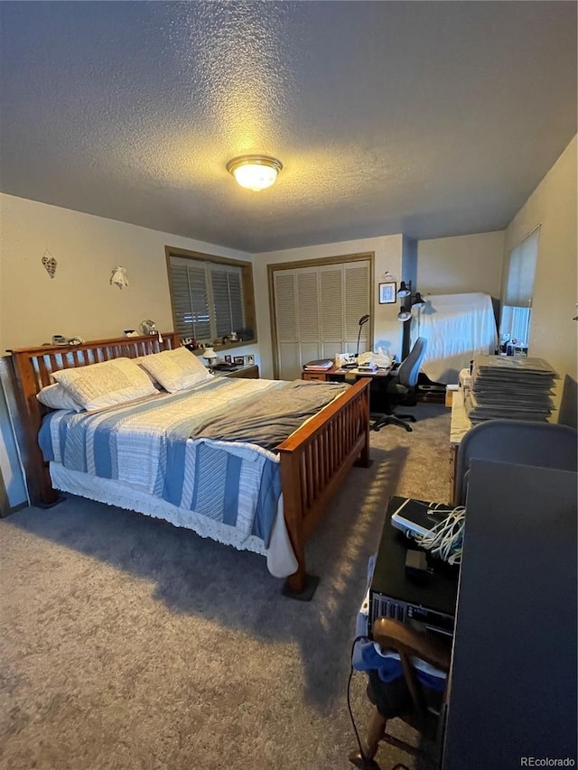 carpeted bedroom featuring a textured ceiling