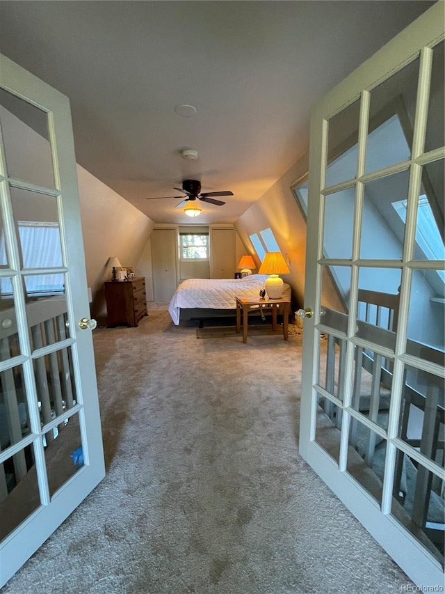 unfurnished bedroom with ceiling fan, carpet floors, and vaulted ceiling