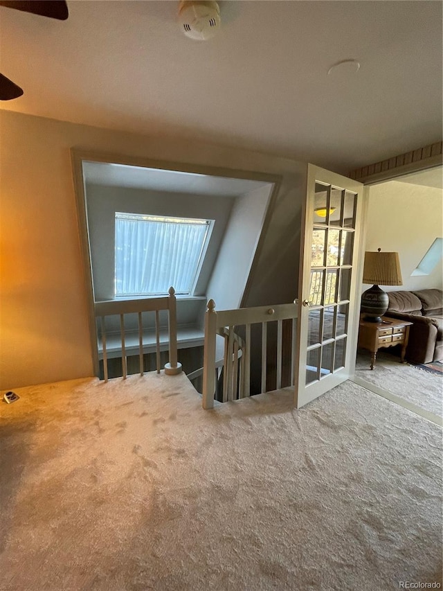 hallway featuring a healthy amount of sunlight and carpet flooring