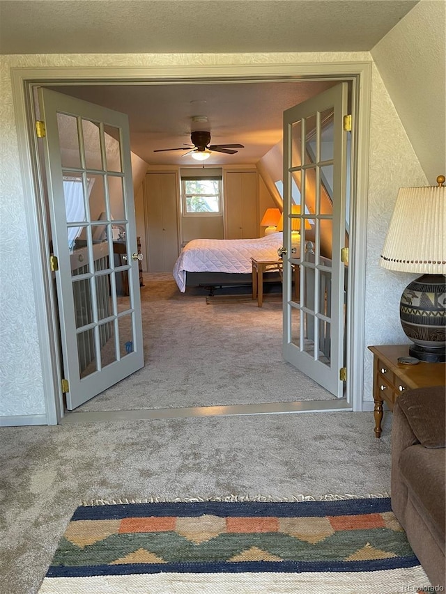 carpeted bedroom with vaulted ceiling, french doors, and ceiling fan