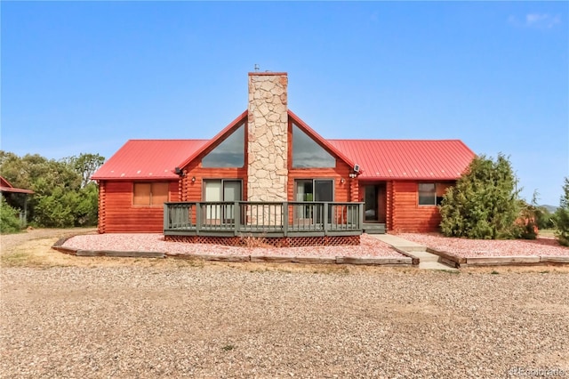 rear view of house featuring a deck