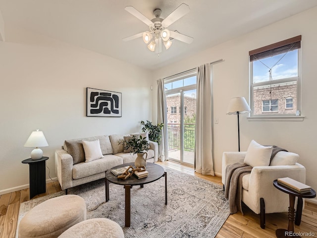 5467 Zephyr Ct Unit 5467, Arvada, CO 80002 - living area featuring light wood-style floors, a ceiling fan, and baseboards