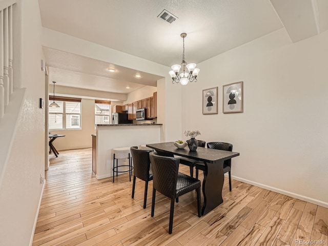 5467 Zephyr Ct Unit 5467, Arvada, CO 80002 - dining room with a chandelier, light wood-style flooring, baseboards, and recessed lighting