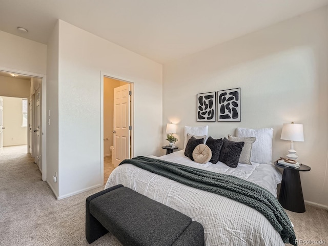 5467 Zephyr Ct Unit 5467, Arvada, CO 80002 - bedroom with light carpet, baseboards, and ensuite bath