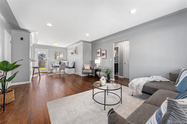 living room featuring baseboards, wood finished floors, and recessed lighting