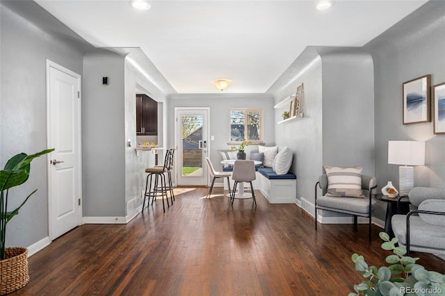 living area featuring baseboards and wood finished floors