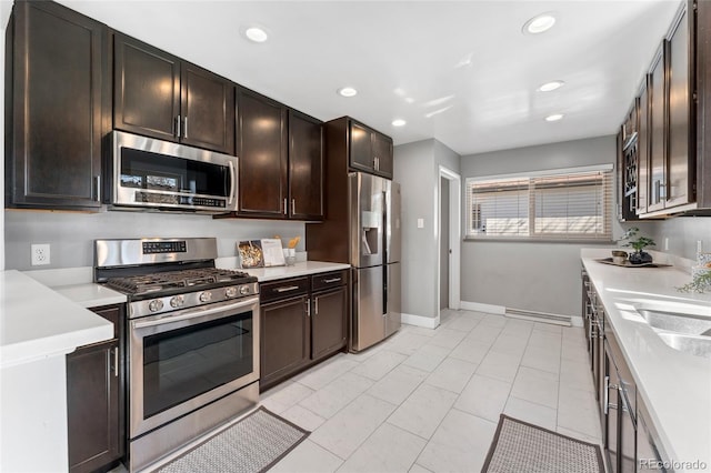 kitchen with recessed lighting, dark brown cabinets, stainless steel appliances, and light countertops