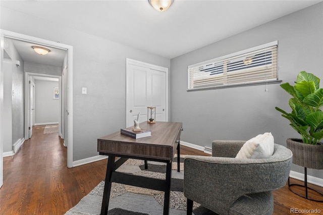 office area featuring wood finished floors, visible vents, and baseboards
