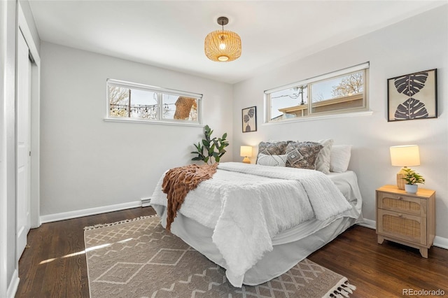 bedroom with wood finished floors and baseboards