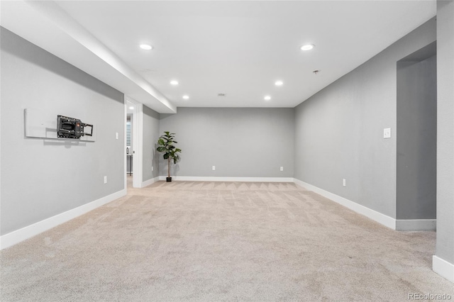 finished basement featuring baseboards, recessed lighting, and light colored carpet