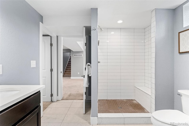 bathroom with visible vents, toilet, a stall shower, and vanity