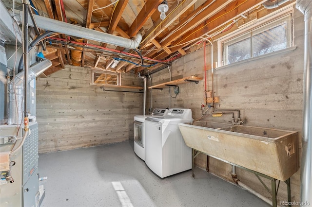 washroom featuring washer and dryer, a sink, and laundry area