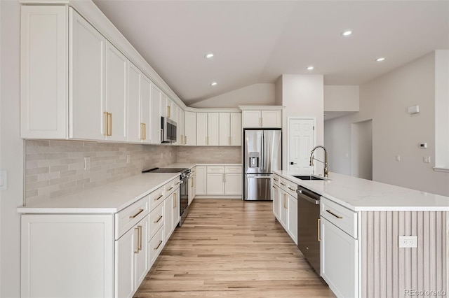 15870 Duckweed Ct, Parker, CO 80134 - kitchen featuring lofted ceiling, light wood-style floors, tasteful backsplash, a sink, and appliances with stainless steel finishes