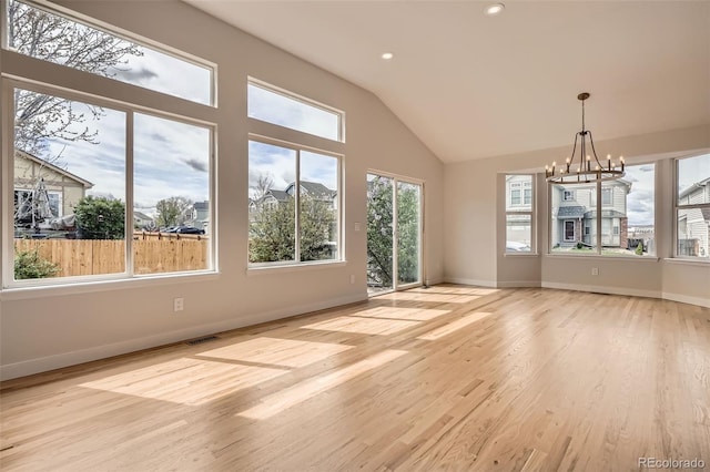 15870 Duckweed Ct, Parker, CO 80134 - interior space featuring visible vents, lofted ceiling, baseboards, light wood finished floors, and a notable chandelier