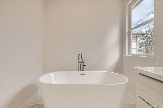 15870 Duckweed Ct, Parker, CO 80134 - full bath with baseboards, a freestanding tub, and vanity