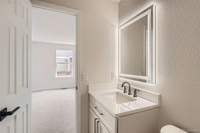 15870 Duckweed Ct, Parker, CO 80134 - bathroom with vanity, a textured wall, and toilet