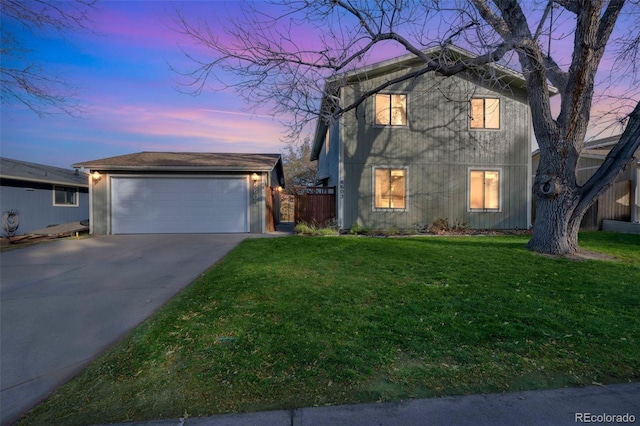 view of front of home featuring a garage, an outdoor structure, and a lawn