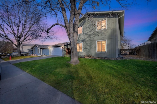 view of front of house featuring a yard and a garage