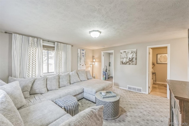 carpeted living room with a textured ceiling