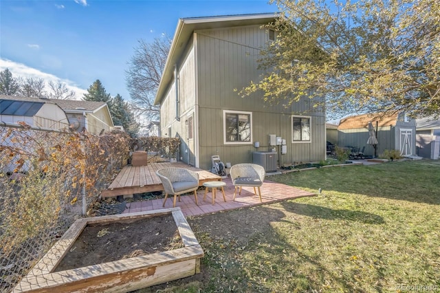 view of yard featuring cooling unit, a shed, and a deck