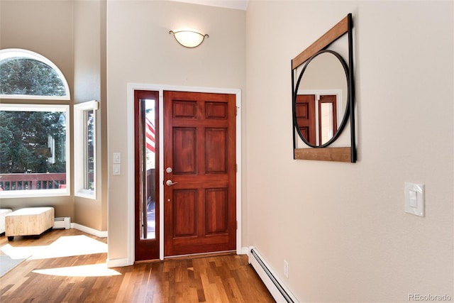 8171 S Homesteader Dr, Morrison, CO 80465 - entrance foyer featuring plenty of natural light, wood finished floors, a baseboard radiator, and baseboards