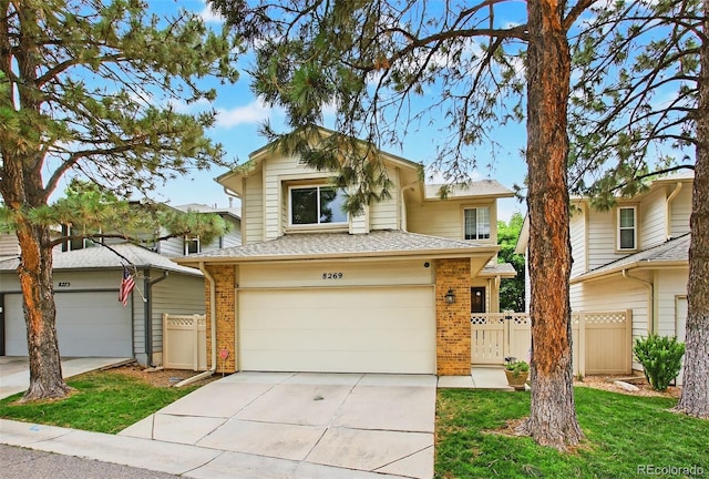 8269 S Gaylord Cir, Centennial, CO 80122 - view of front facade with brick siding, driveway, a garage, and a shingled roof