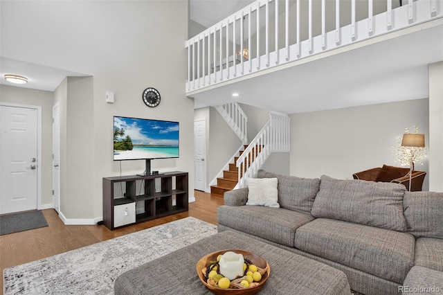 8269 S Gaylord Cir, Centennial, CO 80122 - living area with wood finished floors, a towering ceiling, and stairway