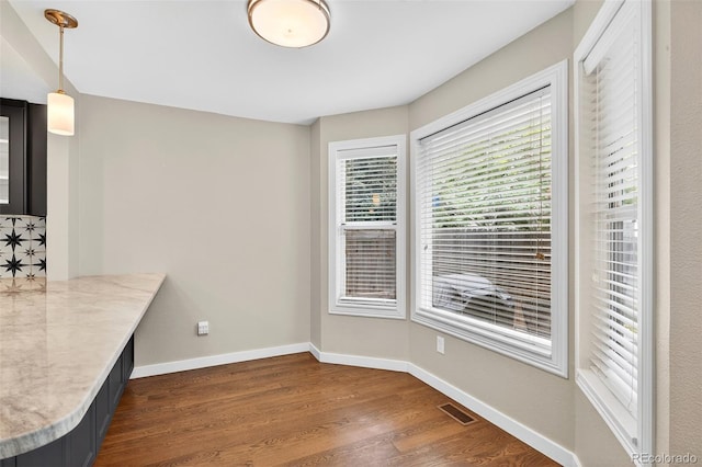 8269 S Gaylord Cir, Centennial, CO 80122 - unfurnished dining area featuring dark wood-type flooring and baseboards