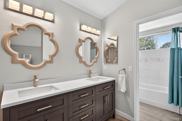 8269 S Gaylord Cir, Centennial, CO 80122 - bathroom with wood finished floors, double vanity, and shower / bathtub combination with curtain