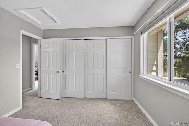 8269 S Gaylord Cir, Centennial, CO 80122 - unfurnished bedroom featuring light colored carpet, attic access, multiple windows, and a closet