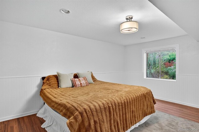 8269 S Gaylord Cir, Centennial, CO 80122 - bedroom with wood finished floors and a wainscoted wall