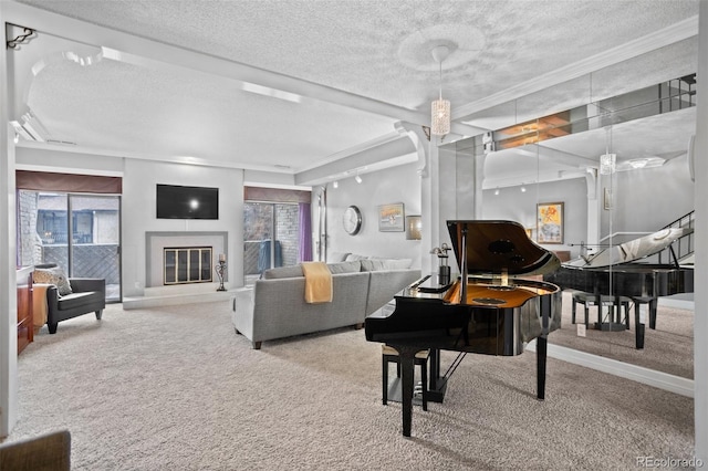 living room featuring carpet floors, crown molding, a textured ceiling, and a glass covered fireplace