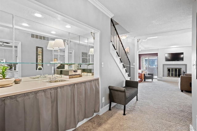 interior space with carpet floors, visible vents, baseboards, a glass covered fireplace, and recessed lighting