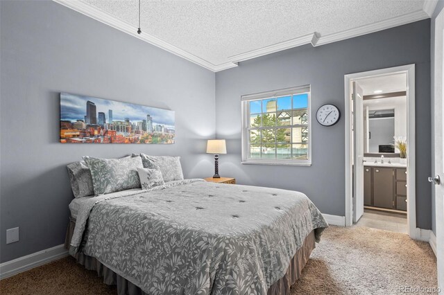 carpeted bedroom featuring a textured ceiling, baseboards, ornamental molding, ensuite bath, and a sink