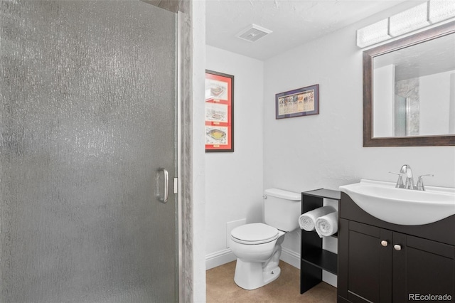 bathroom featuring toilet, vanity, visible vents, a stall shower, and baseboards